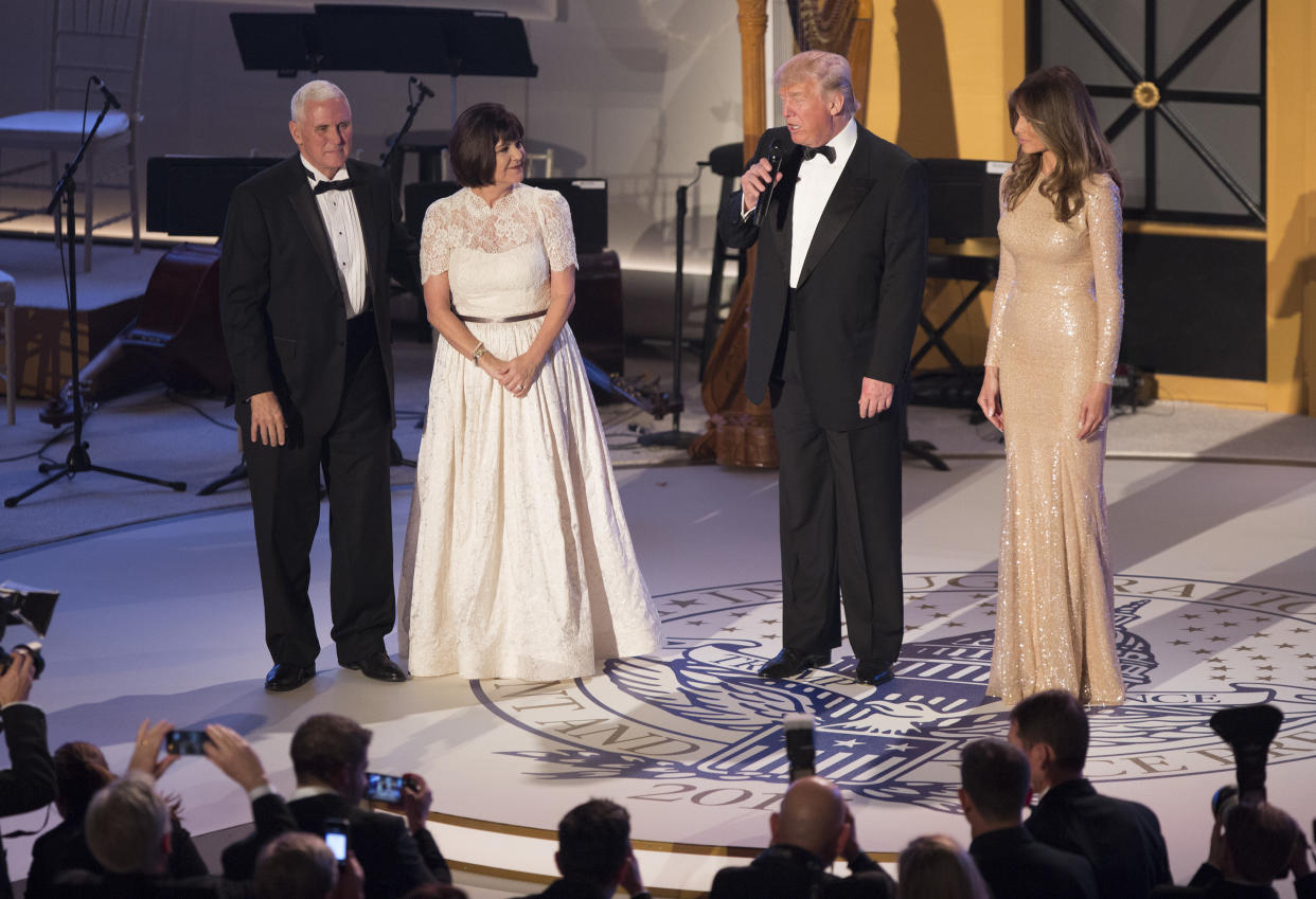 Second lady Karen Pence wore a white gown to a 2017 ball with husband Mike Pence and President and Melania Trump. (Photo: Getty Images)