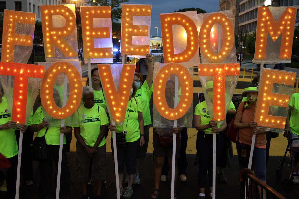 Voting rights activists march in Black Lives Matter Plaza in Washington DC on 17 July. (Getty Images)
