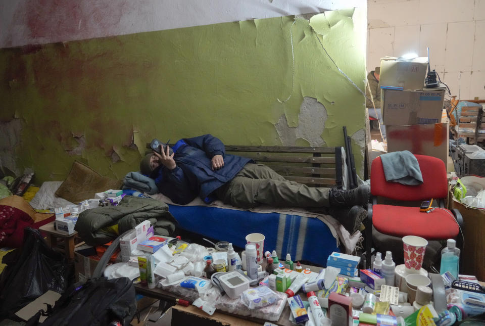 A local citizen rests in a basement for shelter in the center of the town of Irpin, some 25 km (16 miles) northwest of Kyiv, Friday, March 11, 2022. Kyiv northwest suburbs such as Irpin and Bucha have been enduring Russian shellfire and bombardments for over a week prompting residents to leave their home. (AP Photo/Efrem Lukatsky)