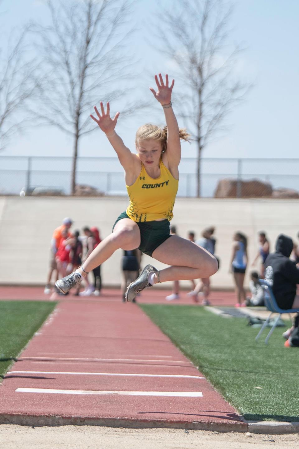 Pueblo County's Kyla Ruzich flys through the air while competing in the triple jump during a meet at Pueblo West High School on Thursday, March 30, 2023.