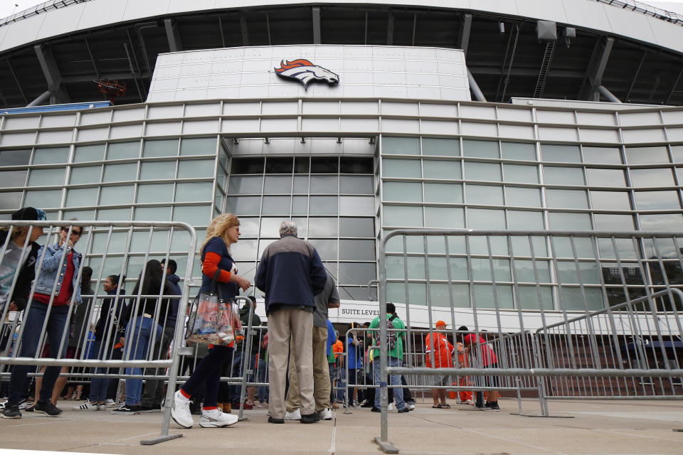 Fans queue up to attend a memorial for Denver Broncos owner Pat Bowlen Tuesday, June 18, 2019 at Mile High Stadium, the NFL football team's home in Denver. Bowlen, who has owned the franchise for more than three decades, died last Thursday. (AP Photo/David Zalubowski)