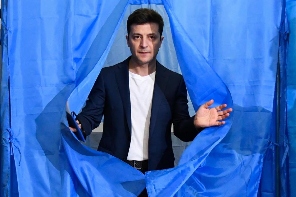 Ukrainian comedian and presidential candidate Volodymyr Zelensky, at a voting booth, is expected to win, according to polls