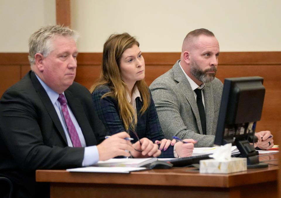 Defense attorneys Mark Collins, left, and his partner, Kaitlyn Stephens, middle, sit next to former Franklin County Sheriff's SWAT deputy Jason Meade during an appearance Feb. 23, 2023, in Franklin County Common Pleas Court.
