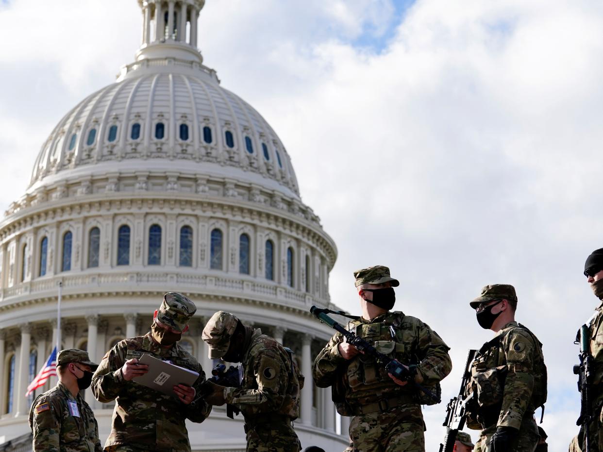 <p>National Guard troops outside the Capitol</p> (Reuters)