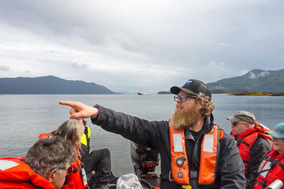 Expedition leader Simon Hook pilots a Zodiac toward shore in Alaska