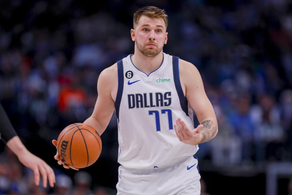 Dallas Mavericks point guard Luka Doncic (77) shrugs to his teammates as he brings the ball up during the second half of an NBA basketball game against the Utah Jazz, Wednesday, Nov. 2, 2022, in Dallas. (AP Photo/Gareth Patterson)