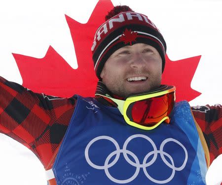 Freestyle Skiing - Pyeongchang 2018 Winter Olympics - Men's Ski Cross Finals - Phoenix Snow Park - Pyeongchang, South Korea - February 21, 2018 - Gold medallist Brady Leman of Canada celebrates with his country flag. REUTERS/Issei Kato