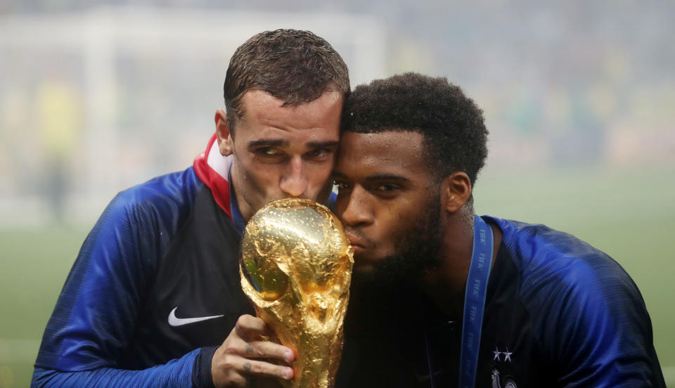 Wäre in Katar wohl gerade noch erlaubt: Die Franzosen Antoine Griezmann und Thomas Lemar knutschen mit der WM-Trophäe.