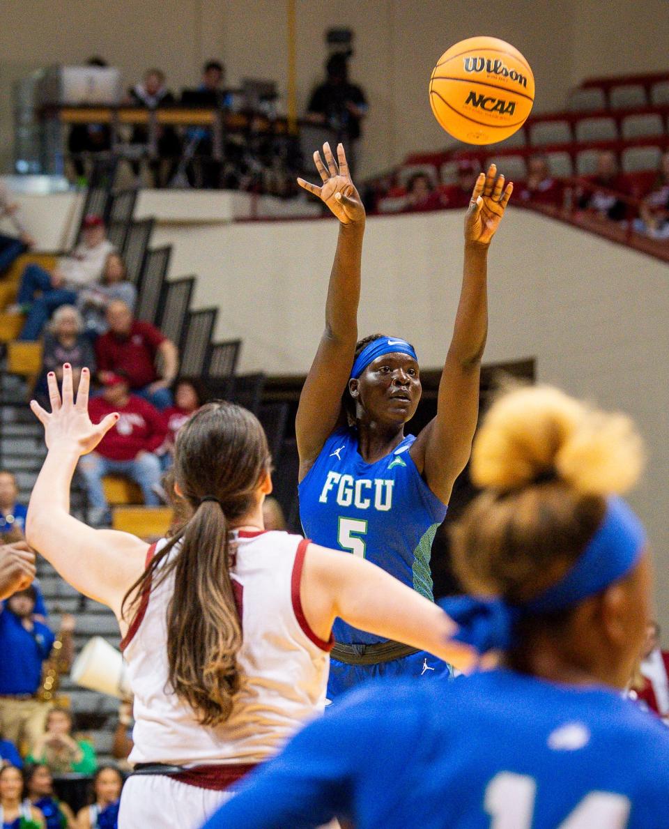 Florida Gulf Coast's Ajulu Thatha (5) shoots a three-pointer during first round NCAA action at Simon Skjodt Assembly Hall on Saturday, March 23, 2204.