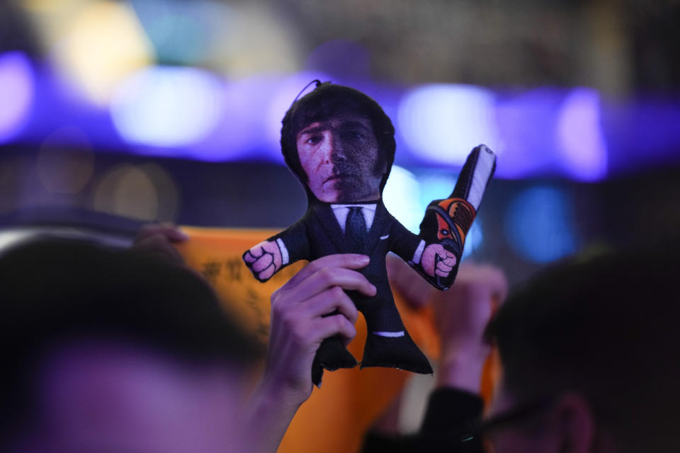 A supporter of presidential candidate of the Liberty Advances coalition Javier Milei holds doll of his candidate with a chainsaw during a campaign rally in Buenos Aires, Argentina, Wednesday, Oct. 18, 2023. General elections are set for Oct. 22. (AP Photo/Natacha Pisarenko)