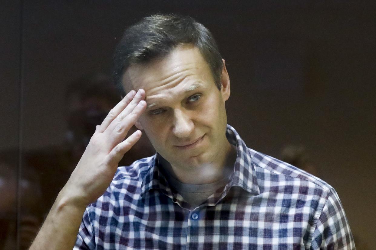 Russian opposition leader Alexei Navalny stands in a dock in the Babuskinsky District Court in Moscow on Feb. 20. 