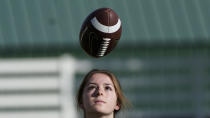 Sam Gordon catches a football, Oct. 20, 2020, in Herriman, Utah. Gordon was the only girl in a tackle football league when she started playing the game at age 9. Now, Gordon hopes she can give girls a chance to play on female-only high school teams through a lawsuit. (AP Photo/Rick Bowmer)