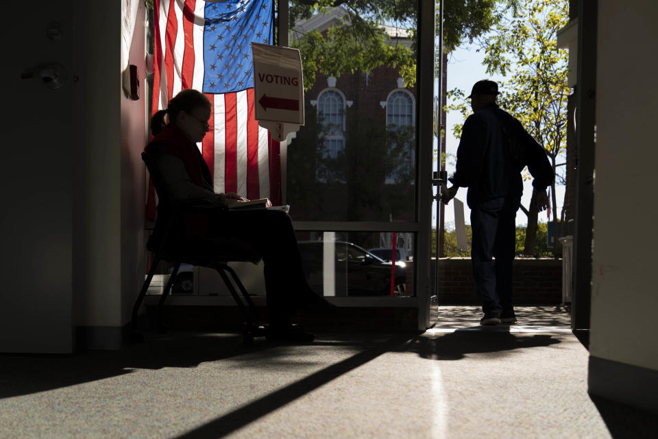 A poll worker greets early voters in Alexandria, Va., on Monday. (Andrew Harnik / AP)