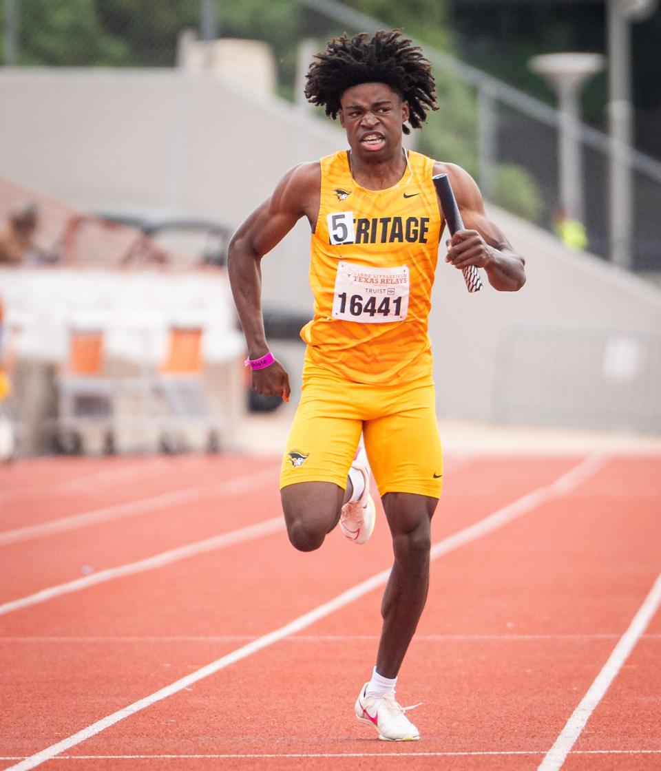 A relay team member from American Heritage High School carries the baton in the 800-meter relay on the final day of the 96th annual Clyde Littlefield Texas Relays on Saturday. American Heritage set a meet record with the run.