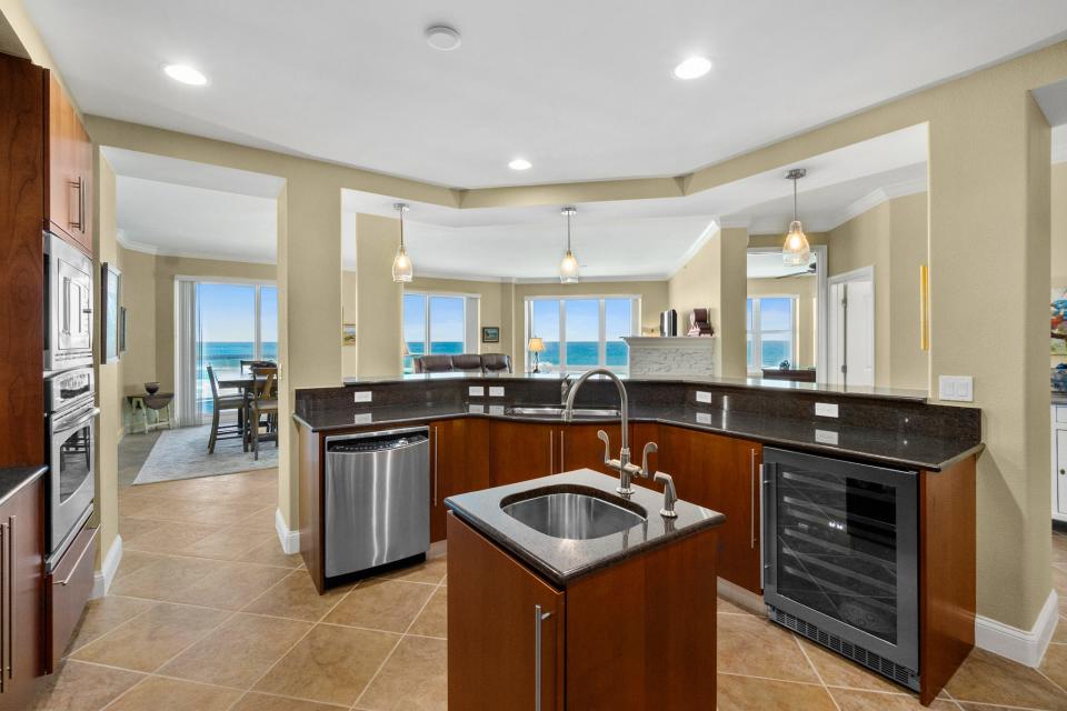 The gourmet kitchen is a “chef's dream,” featuring top-of-the-line appliances, a custom pantry and a curved stone bar.