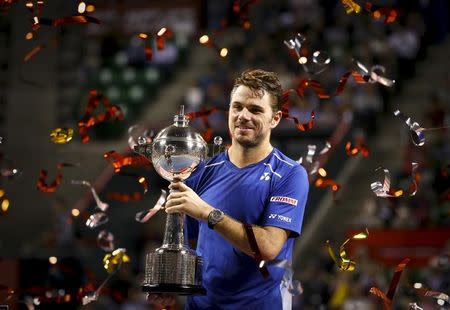 Switzerland's Stan Wawrinka holds the trophy after defeating Benoit Paire of France in the men's tennis single final of the Japan Open championships in Tokyo October 11, 2015. REUTERS/Thomas Peter