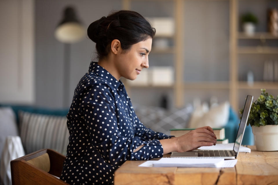 Young woman student using laptop computer