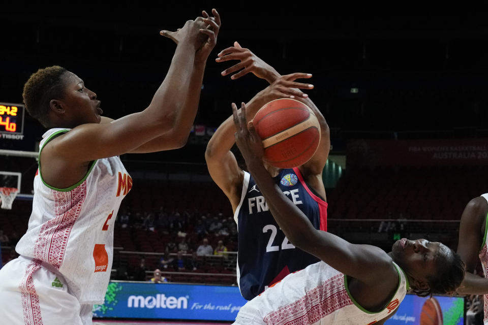 France's Marieme Badiane, centre, competes for the ball with Mali's Salimatou Kourouma, left, and Sika Kone during their game at the women's Basketball World Cup in Sydney, Australia, Sunday, Sept. 25, 2022. (AP Photo/Mark Baker)