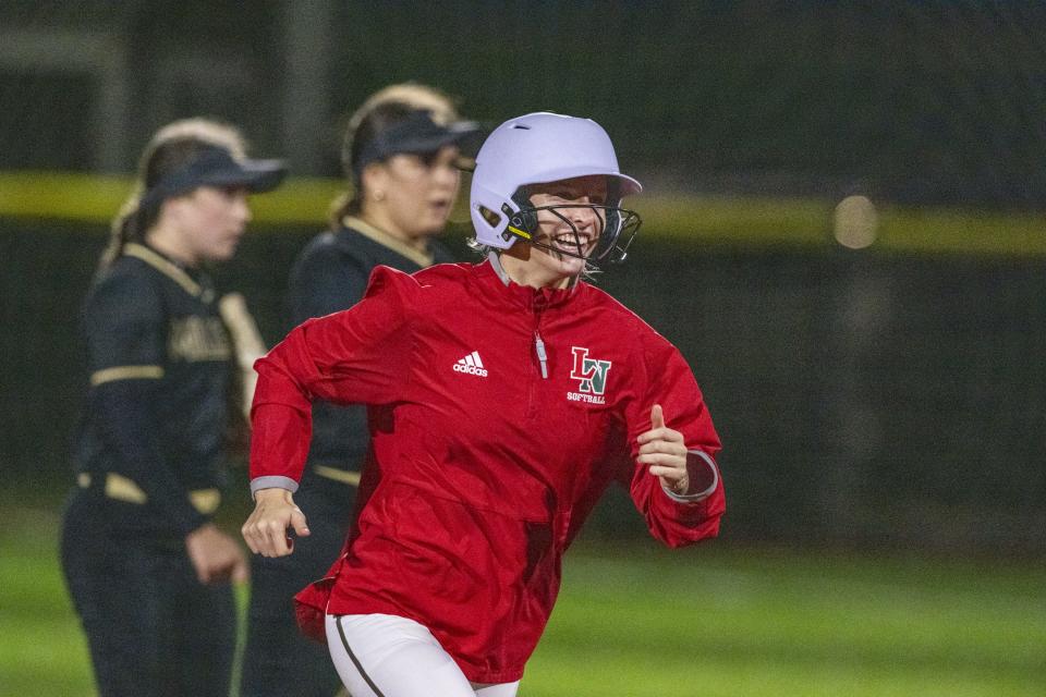 Lawrence North High School senior Gabby Peck (14) rounds the bases after hitting a 2-run homer during an IHSAA softball game against Noblesville High School, Friday, April 12, 2024, at Lawrence North High School.