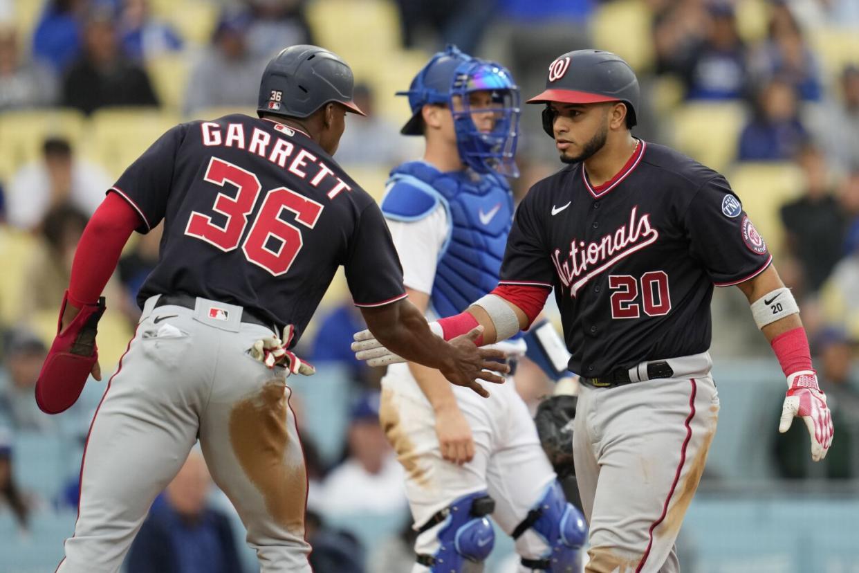 Washington Nationals' Keibert Ruiz celebrates with Stone Garrett after hitting a home run.