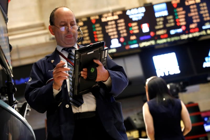 A trader works on the floor of the New York Stock Exchange near the closing bell of the trading session in New York City