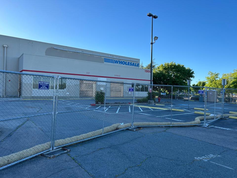 A fence surrounds the old Costco building on Dana Drive on Thursday, May 9, 2024, as demolition work on a portion of the building is underway to make room for an At Home store.