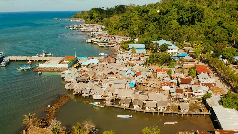 Old wooden house standing on the sea in the fishing village. City port on Balabac island, Palawan, Philippines.