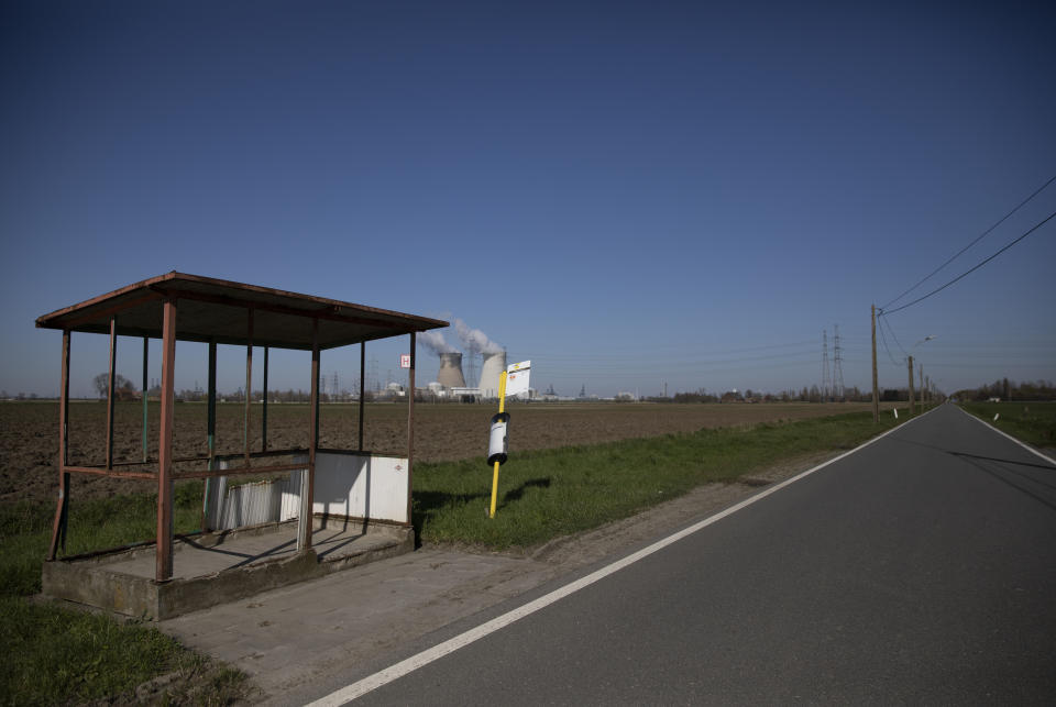 An empty bus stop on a deserted road in Doel, Belgium, Monday, March 23, 2020. Belgium's stores, schools, restaurants and bars have closed and citizens have been asked to stay at home or to maintain a social distance from others. For most people, the new coronavirus causes only mild or moderate symptoms, such as fever and cough. For some, especially older adults and people with existing health problems, it can cause more severe illness, including pneumonia. (AP Photo/Virginia Mayo)