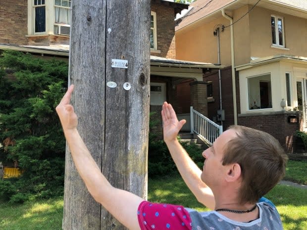 Chad Barnard shows where the CCTV camera was installed on his street. Before it was removed, the camera pointed directly into his bedroom window, he said. (Rob Krbavac/CBC - image credit)