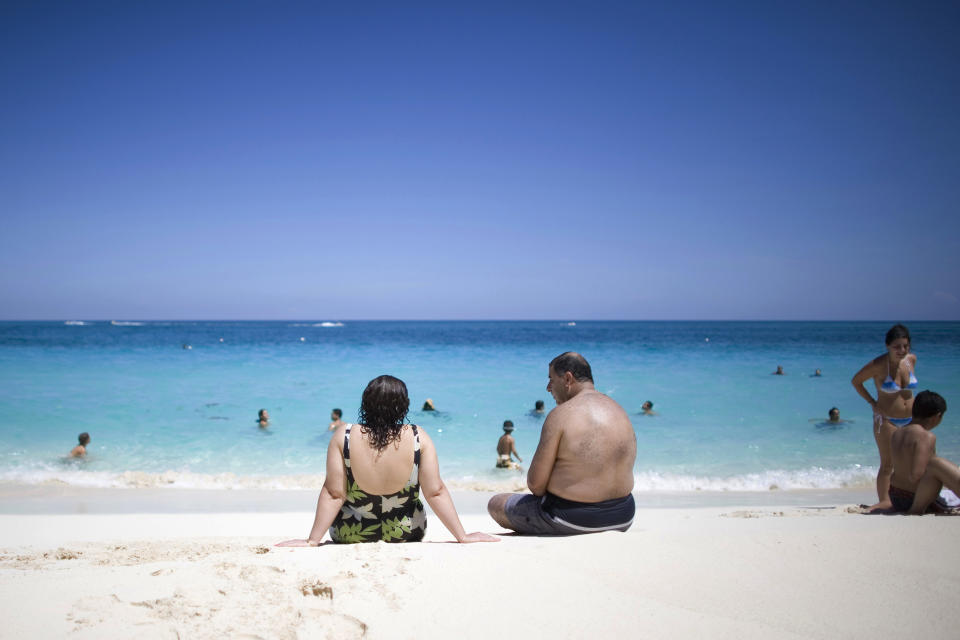 Tourists sunbathe along the beach in Nassau, Bahamas, Saturday, Sept. 6, 2008. (AP Photo/Alexandre Meneghini)