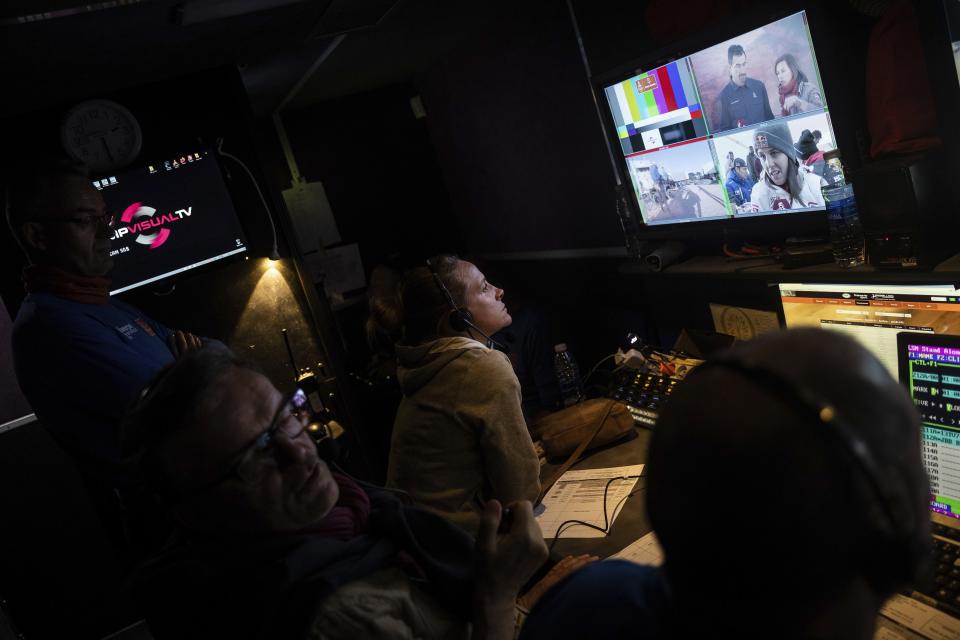 In this Monday, Jan. 13, 2020 photo, Dakar TV staffers work inside the broadcast truck after stage eight in Wadi Al Dawasir, Saudi Arabia. Formerly known as the Paris-Dakar Rally, the race was created by Thierry Sabine after he got lost in the Libyan desert in 1977. Until 2008, the rallies raced across Africa, but threats in Mauritania led organizers to cancel that year's event and move it to South America. It has now shifted to Saudi Arabia. The race started on Jan. 5 with 560 drivers and co-drivers, some on motorbikes, others in cars or in trucks. Only 41 are taking part in the Original category. (AP Photo/Bernat Armangue)