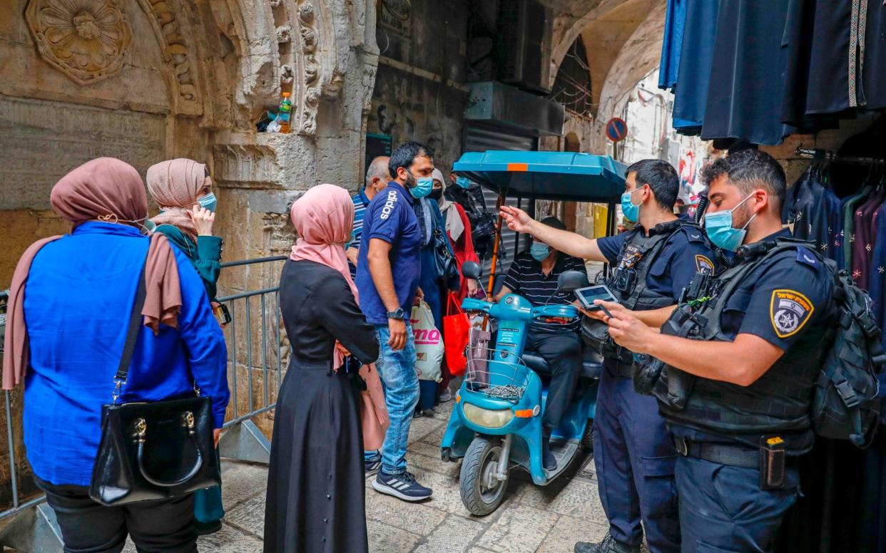 Israeli police officers enforce coronavirus regulations in Jerusalem's Old City - AFP