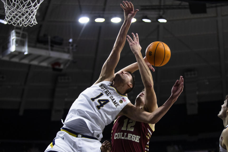 Notre Dame's Nate Laszewski (14) and Boston College's Quinten Post (12) fight for a rebound during an NCAA college basketball game Saturday, Jan. 21, 2023 in South Bend, Ind. (AP Photo/Michael Caterina)