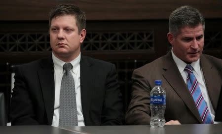 Chicago police officer Jason Van Dyke (L), reacts to his guilty verdict, as his attorney Daniel Herbert looks on during his trial for the shooting death of Laquan McDonald, in Chicago, Illinois, Oct. 5, 2018. Antonio Perez/Chicago Tribune/Pool via REUTERS/Files