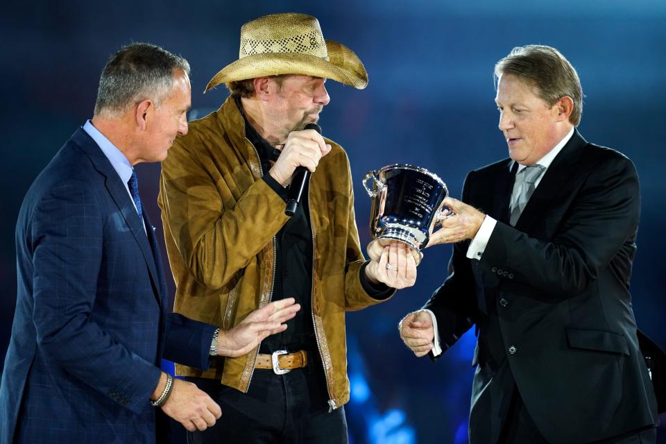 Toby Keith, center, accepts the BMI Icon award onstage from BMI VP of Creative Nashville, Clay Bradley, right, and president and CEO of BMI Mike O'Neill, left, during the BMI’s 70th Annual Country Awards at the BMI Music Row Headquarters in Nashville, Tenn., Tuesday, Nov. 8, 2022.