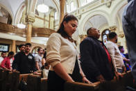Parishioners pray during Easter Mass at Sacred Heart of Jesus and Saint Patrick, Sunday, March 31, 2024, in Baltimore, Md. (AP Photo/Julia Nikhinson)