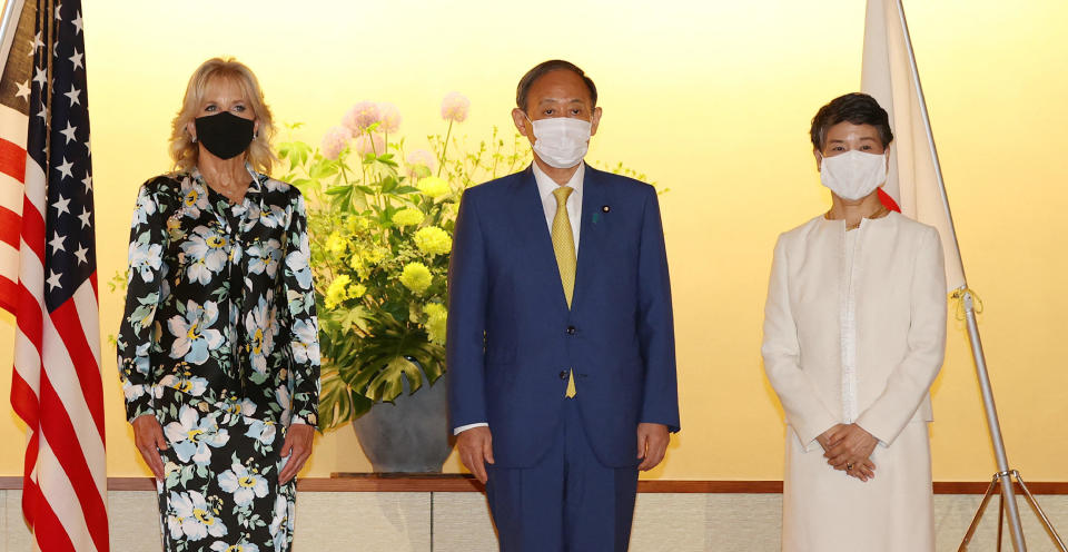 Japanese Prime Minister Yoshihide Suga (C) and his wife Mariko Suga meet with first lady Jill Biden (L) at the Akasaka State Guest House in Tokyo on July 22, 2021 on the eve of Tokyo 2020 Olympic Games.  / Credit: STR/JAPAN POOL/AFP via Getty Images