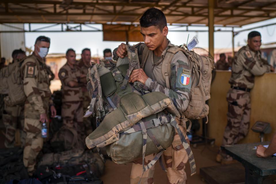 French Barkhane force soldiers who wrapped up a four-month tour of duty in the Sahel leave their base in Gao, Mali Wednesday June 9, 2021. France has suspended joint military operations with Malian forces until the junta led by Col. Assimi Goita, who retook control of Mali's transitional government May 24, complies with international demands to restore civilian rule. (AP Photo/Jerome Delay)