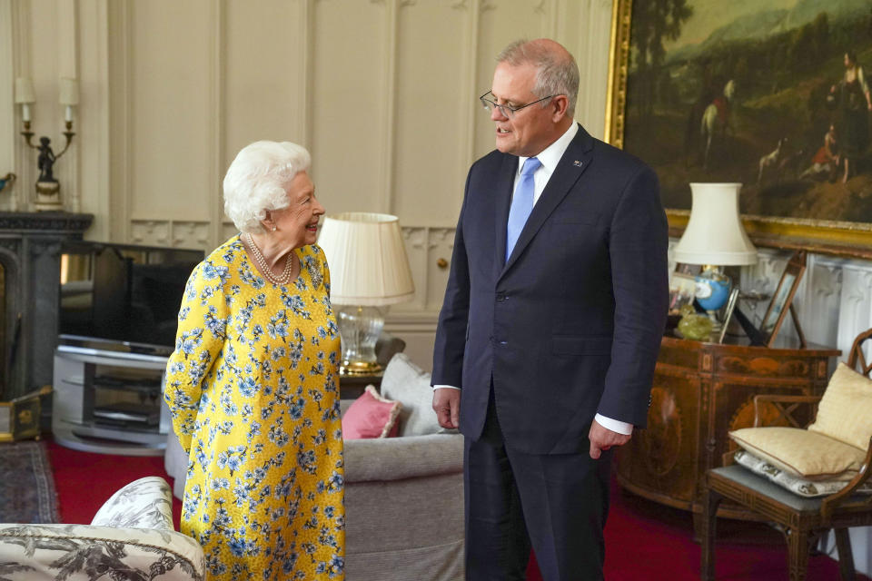 Britain's Queen Elizabeth II, left receives Australian Prime Minister Scott Morrison during an audience in the Oak Room at Windsor Castle, in Windsor, England, Tuesday June 15, 2021. (Steve Parsons/Pool Photo via AP)