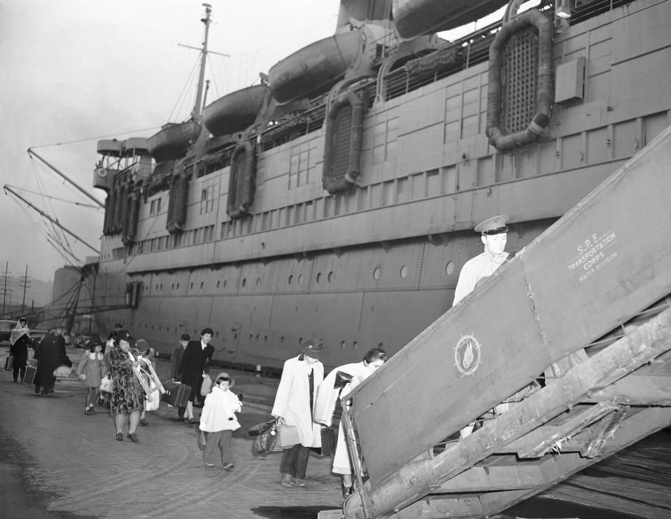 FILE - In this Dec. 7, 1945, file photo, some of the 991 Japanese repatriates, who boarded the steamship Matsonian in Seattle the final lap of their trip home to Japan. Most came from Texas, where they had been held in an internment camp. (AP Photo, File)