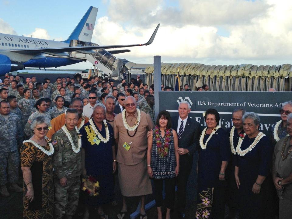 Vice President Mike Pence stands with his wife Karen as they pose for a photo with officials and U.S. service members during a refueling stop in Pago Pago, American Samoa,