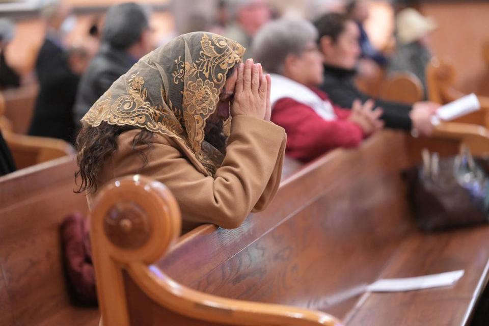 A woman prays during Mass at the Cathedral of the Blessed Sacrament in downtown on Sunday, the day after the Sacramento Diocese announced that it would file for bankruptcy protection in the wake of hundreds of sexual abuse lawsuits.