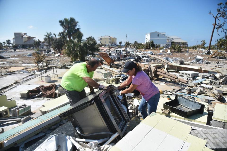 People try to recover belongings from house destroyed by Hurricane Michael (AFP/Getty Images)