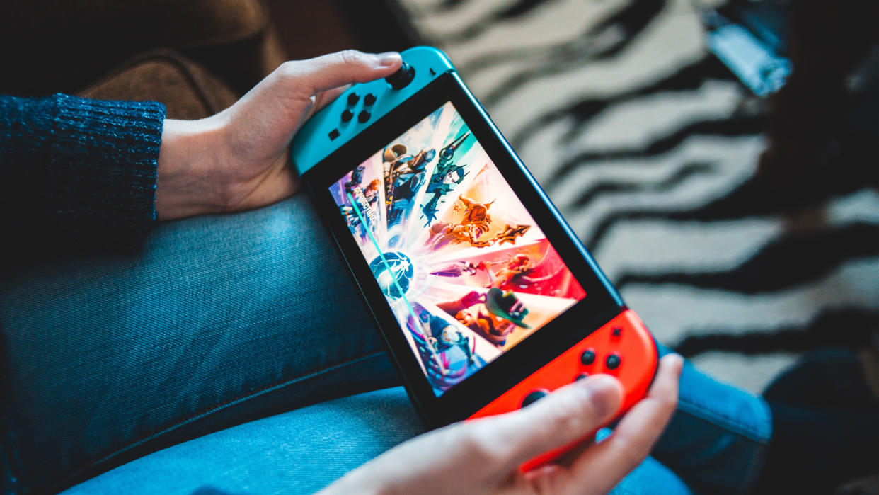  A shot of a gamer playing a Nintendo Switch. 