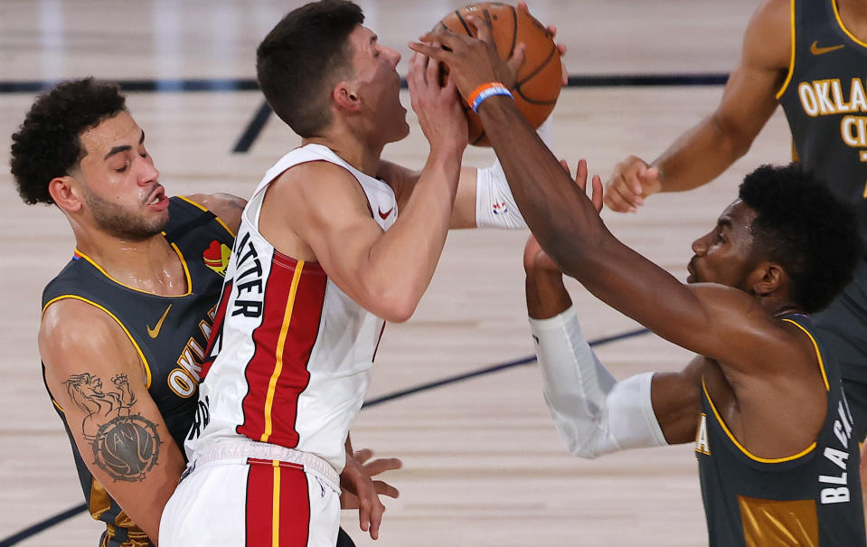 Oklahoma City Thunder's Hamidou Diallo, right, and Abdel Nader defend against Miami Heat's Tyler Herro during the first quarter of an NBA basketball game Wednesday, Aug. 12, 2020, in Lake Buena Vista, Fla. (Kevin C. Cox/Pool Photo via AP)