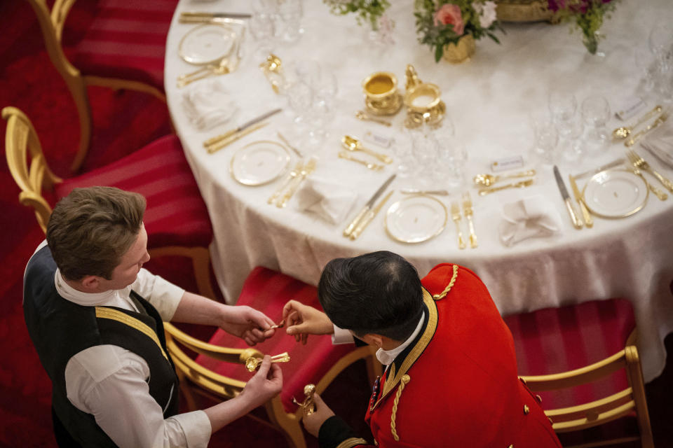 The finishing touches are applied to the tables in the Ballroom of Buckingham Palace, before the State Banquet for the State Visit by Emperor Naruhito and his wife, Empress Masako of Japan, in London, Tuesday June 25, 2024. (Aaron Chown/PA via AP)