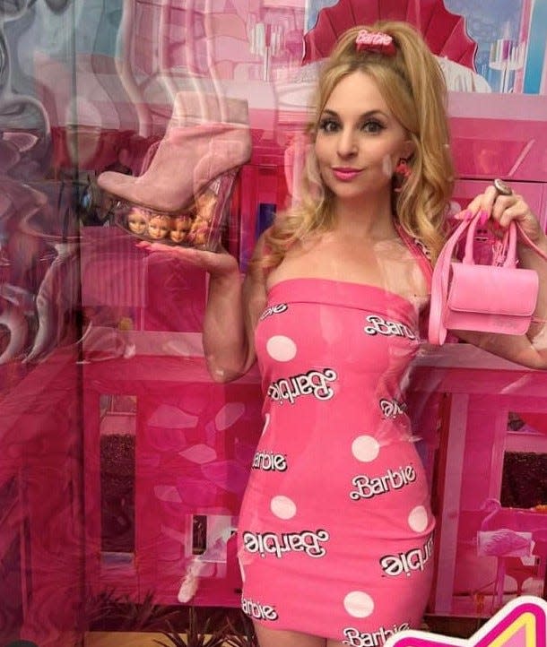 Helena Levin aka California Barbie Princess strikes a pose inside a Mattel Barbie box photo booth at Alamo Drafthouse Cinema in San Francisco in July 2023.