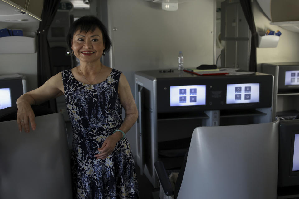 Kim Phuc poses for a picture in a humanitarian flight transporting refugees fleeing the war in Ukraine to Canada, from Frederic Chopin Airport in Warsaw, Poland, Monday, July 4, 2022. Phuc, the girl in the famous 1972 Vietnam napalm attack photo, on Monday escorted 236 refugees from the war in Ukraine on a flight from Warsaw to Canada. Phuc’s iconic Associated Press photo in which she runs with her napalm-scalded body exposed, was etched on the private NGO plane that is flying the refugees to the city of Regina. (AP Photo/Michal Dyjuk)