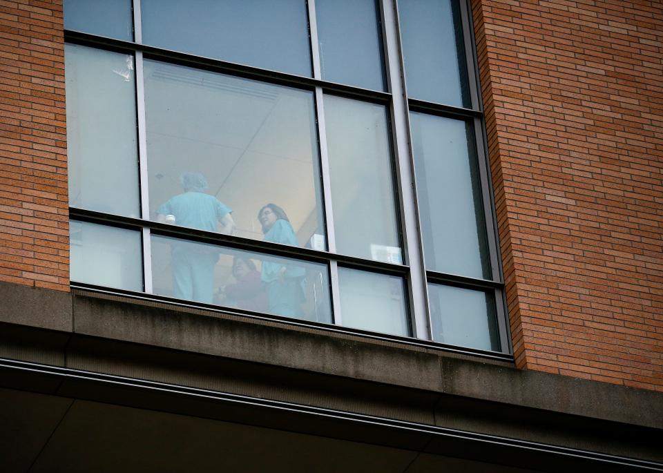 FILE PHOTO: Employees dressed in scrubs talk with each other at Providence Regional Medical Center after a spokesman from the U.S. Centers for Disease Control and Prevention (CDC) said a traveler from China has been the first person in the United States to be diagnosed with the Wuhan coronavirus, in Everett, Washington, U.S. January 21, 2020.  REUTERS/Lindsey Wasson