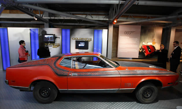 Visitors look at the Ford Mustang Mach 1, featured in the 1971 James Bond film "Diamonds Are Forever" on display during the opening of a press preview of the Bond in Motion exhibition at the Beaulieu National Motor Museum at Brockenhurst in the southern English county of Hampshire on January 15, 2012. The Bond in Motion exhbition features fifty original iconic vehicles used in the James Bond films to celebrate fifty years of 007 and will open to the public from January 17. AFP PHOTO / JUSTIN TALLIS